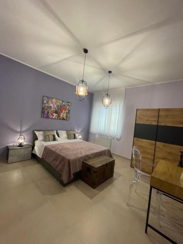 a bedroom with a large bed and two lights at B&B Tregì in Lamezia Terme