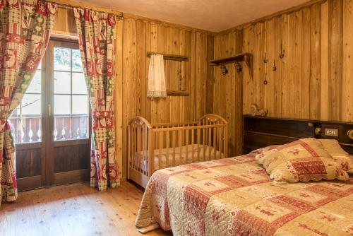 um quarto com uma cama e uma janela em Albergo Boule de Neige em Rhêmes-Notre-Dame