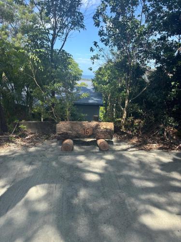 a stone bench sitting in the middle of a road at Sandbar views in Smiths Lake