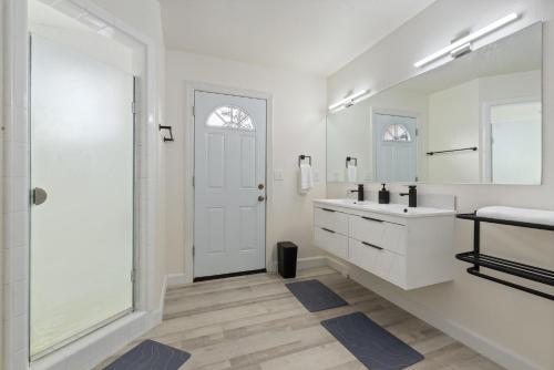 a white bathroom with a sink and a mirror at Luxury Family Villa Sleeps 20 in Coarsegold