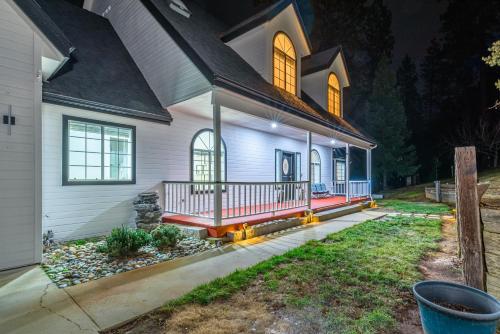 a white house with a porch with a red deck at Luxury Family Villa Sleeps 20 in Coarsegold