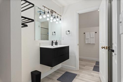 a bathroom with a sink and a mirror at Luxury Family Villa Sleeps 20 in Coarsegold