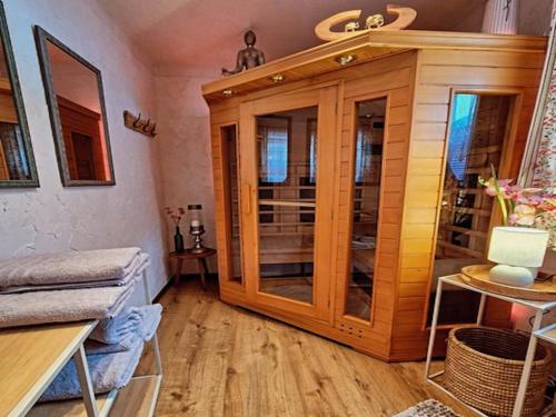 a room with a wooden cabinet with glass doors at Holiday Home Muhr near Ski Slopes in Muhr