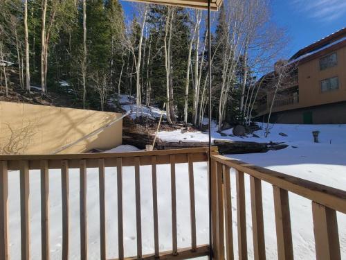 a snow covered yard with a fence and trees at Cozy Retreat with Scenic Views- Prestige Vacations in Brian Head
