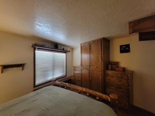 a bedroom with a large bed and a window at Cozy Retreat with Scenic Views- Prestige Vacations in Brian Head