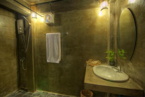 a bathroom with a sink and a mirror at Old Khmer House in Siem Reap