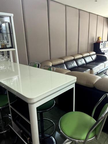 a table and chairs in a room with a couch at JZ at Bandar Baru Klang Townhouse in Klang