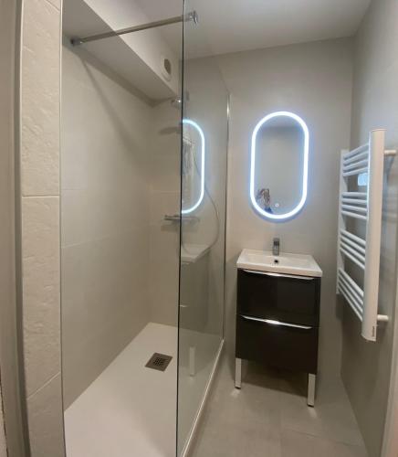 une salle de bain avec une douche en verre et un lavabo dans l'établissement La Baule, studio cosy. Quartier Jumping/Atlantia, à La Baule