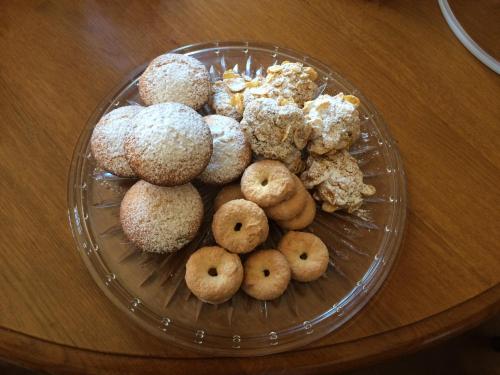 a glass plate of donuts on a table at Masseria del Vino in Loreto Aprutino