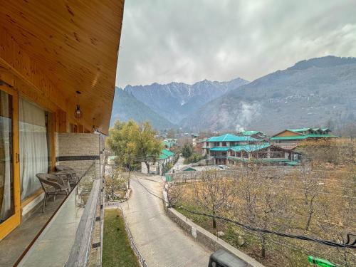 a balcony of a house with a view of a mountain at CHAMBYAL's RETREAT in Manāli