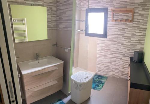 une salle de bain avec un lavabo et des toilettes et une fenêtre dans l'établissement villa jérémy, à Bonifacio