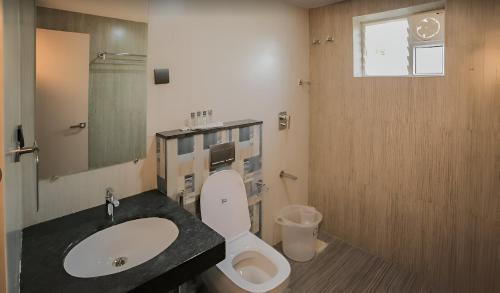 a bathroom with a sink and a toilet at Pph Royal GS Comforts Opp Mall of Asia in Bengaluru