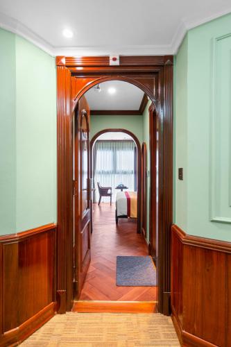 a hallway leading to a room with a bed at 12 A&B Điện Biên Phủ Hà Nội Hotel in Hanoi