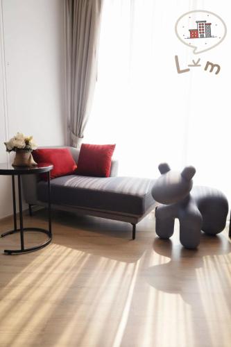 a living room with a couch and a table at The Central Pattaya High Floor, Pattaya City in Pattaya Central