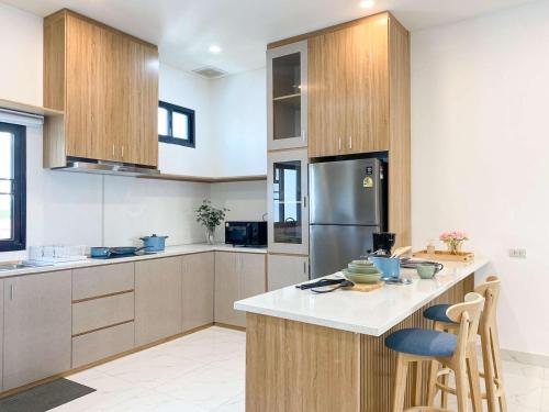 a kitchen with wooden cabinets and a counter top at Click Residence, Si Muang in Vientiane