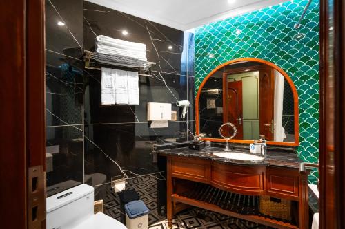 a bathroom with a sink and a mirror at 12 A&B Điện Biên Phủ Hà Nội Hotel in Hanoi
