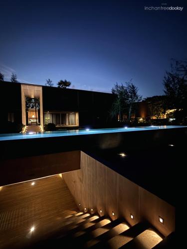 a night view of a building with lights at inchantreedoolay huahin in Pran Buri