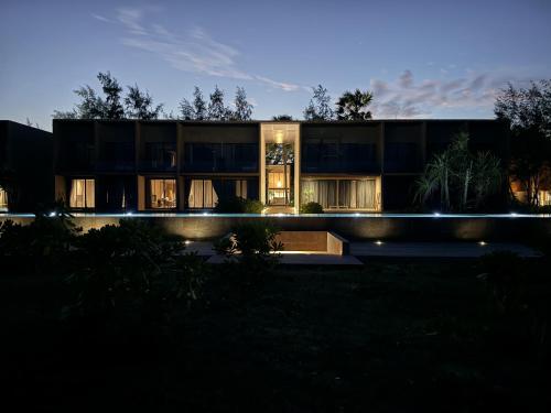 a house lit up at night at inchantreedoolay huahin in Pran Buri