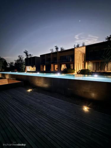 a building with lights in front of it at night at inchantreedoolay huahin in Pran Buri