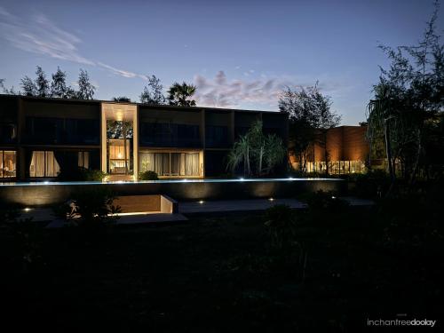 a building with lights in front of it at night at inchantreedoolay huahin in Pran Buri