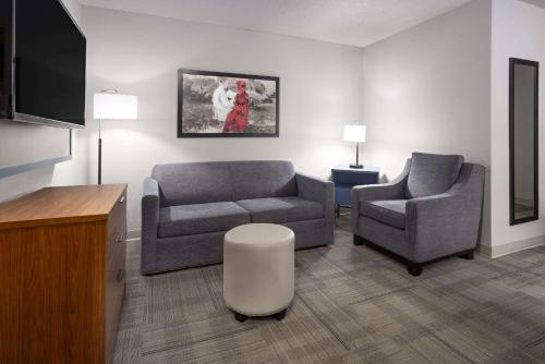 a living room with a couch and a chair at AmericInn by Wyndham Iron Mountain in Iron Mountain