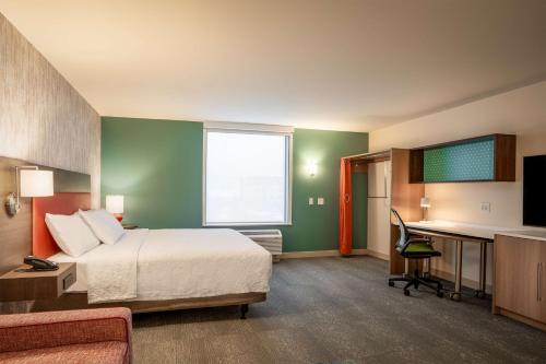 a hotel room with a bed and a desk at Home2 Suites by Hilton Bozeman Midtown in Bozeman