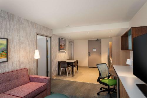 a living room with a couch and a table at Home2 Suites by Hilton Bozeman Midtown in Bozeman