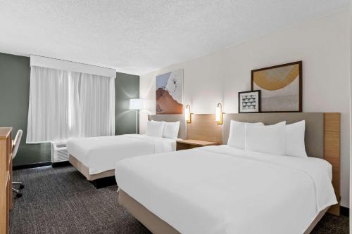 a hotel room with two beds and a television at Spark By Hilton Bensalem Philadelphia in Bensalem