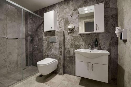 a bathroom with a toilet and a sink and a shower at Days Inn by Wyndham Alanya in Alanya