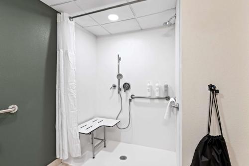 a bathroom with a shower with a shower curtain at Spark By Hilton Bensalem Philadelphia in Bensalem