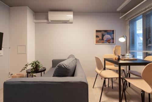 a living room with a couch and a table at Mi-HOTEL OTSUKA in Tokyo
