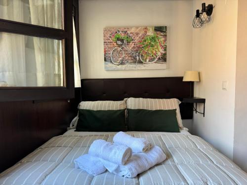 two towels on a bed in a bedroom at Apartamento Corredera in Córdoba