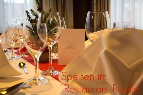 a table with wine glasses and a napkin on it at Hotel Restaurant Rössle in Rankweil