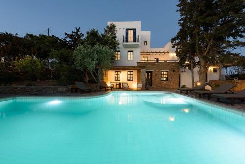 a large swimming pool in front of a house at Villa Padma, Agkeria Paros in Angairiá