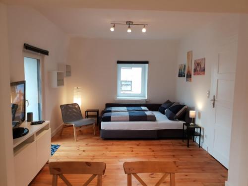 a bedroom with a bed and a chair in it at Apartment 28 - Parkplatz in Coburg