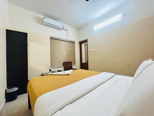 a bedroom with a large bed and a window at Vaisharad Homestay Trivandrum in Trivandrum