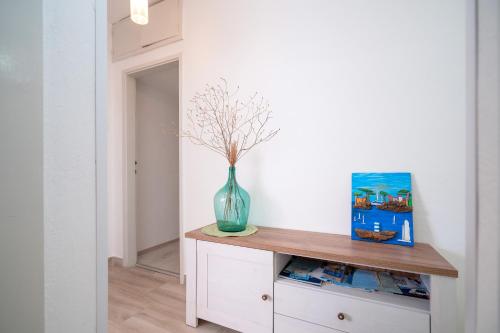 a vase sitting on a cabinet in a hallway at Seafront Stone Home With King Beds, Garden And Balcony in Stari Grad