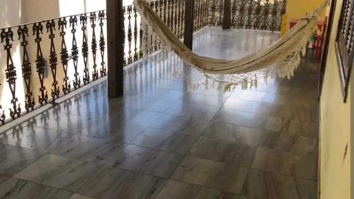 a hammock on a staircase in a house at Hostel Eldorado Contagem in Contagem