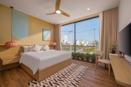 a hotel room with a bed and a large window at Kim Son Pool Villa Da Nang in Da Nang