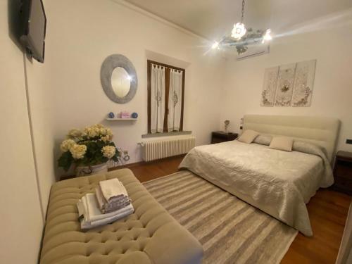 a bedroom with a bed and a couch at B&B Tenuta Madiba in Ravenna