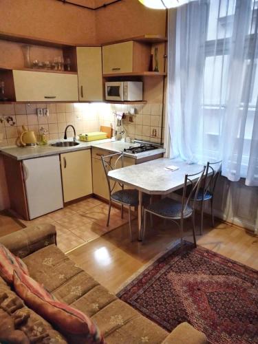 a kitchen with a table and chairs in a room at Delux Kolonada in Karlovy Vary
