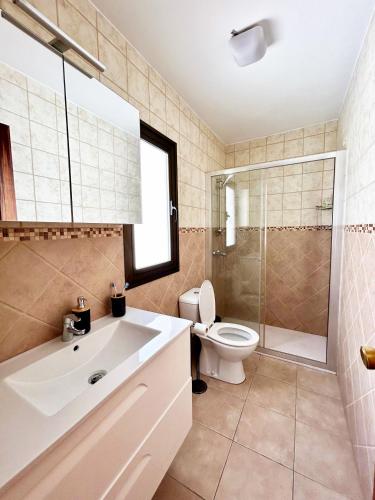 a bathroom with a sink and a toilet and a shower at Sunny Monaco Puerto Rico in Mogán