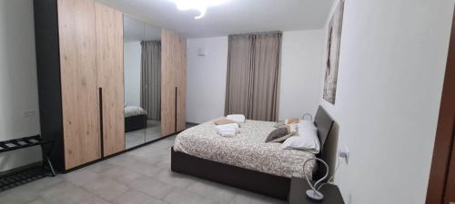 a bedroom with a bed and a large mirror at Casa Faét in Adro