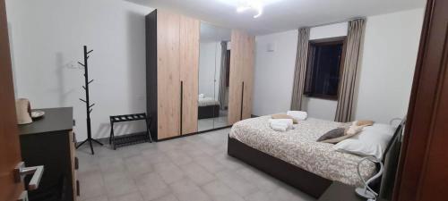 a bedroom with a bed and a large mirror at Casa Faét in Adro