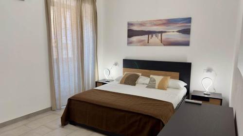 a bedroom with a large bed and a painting on the wall at Casa Faét in Adro