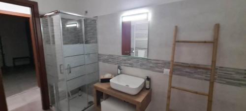 a bathroom with a toilet and a glass shower at Casa Faét in Adro