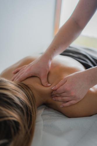 a woman laying on a bed receiving a massage at Summerhill House Hotel in Enniskerry