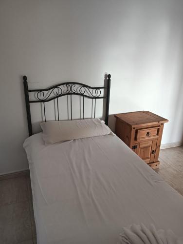a bedroom with a white bed and a wooden table at Sweet Luxury Rooms in Rome