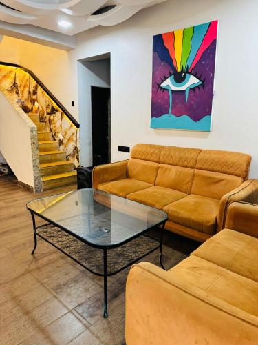 a living room with a couch and a table at S & S with Jacuzzi by Villagram in Lonavala
