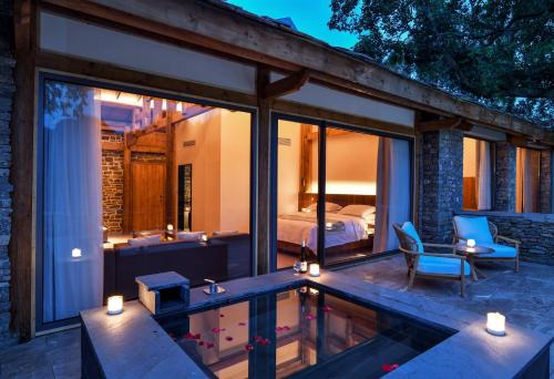 a house with a swimming pool and a bedroom at 至也 黄果树 in Xinggong